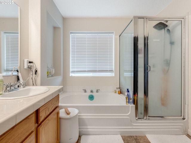 bathroom with tile patterned floors, separate shower and tub, and vanity