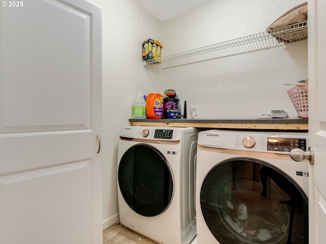 laundry room with separate washer and dryer and light tile patterned floors