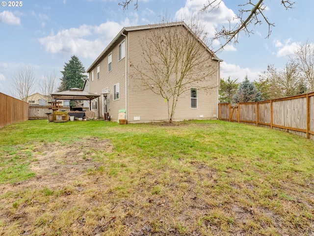 rear view of property with a gazebo and a lawn