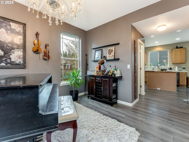 interior space with dark wood-type flooring and a chandelier