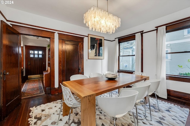 dining room featuring dark hardwood / wood-style flooring and a chandelier