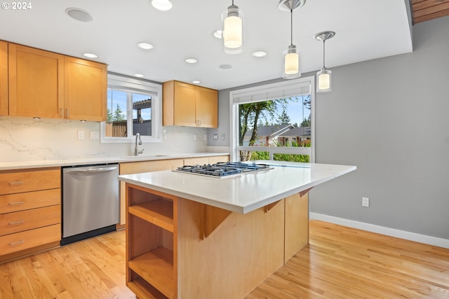 kitchen with a kitchen island, appliances with stainless steel finishes, hanging light fixtures, light countertops, and open shelves