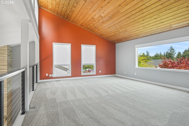 unfurnished room with light carpet, wood ceiling, baseboards, and vaulted ceiling