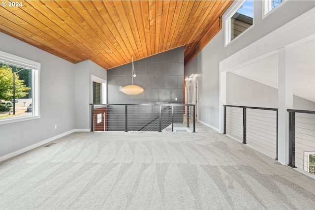 carpeted empty room featuring wooden ceiling, visible vents, baseboards, and high vaulted ceiling