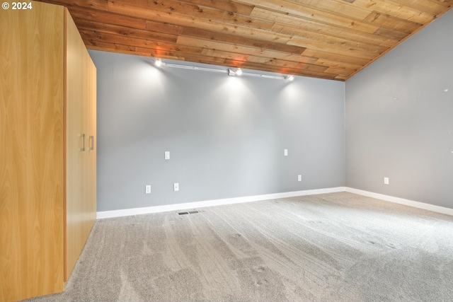 spare room featuring wooden ceiling, carpet flooring, visible vents, and baseboards