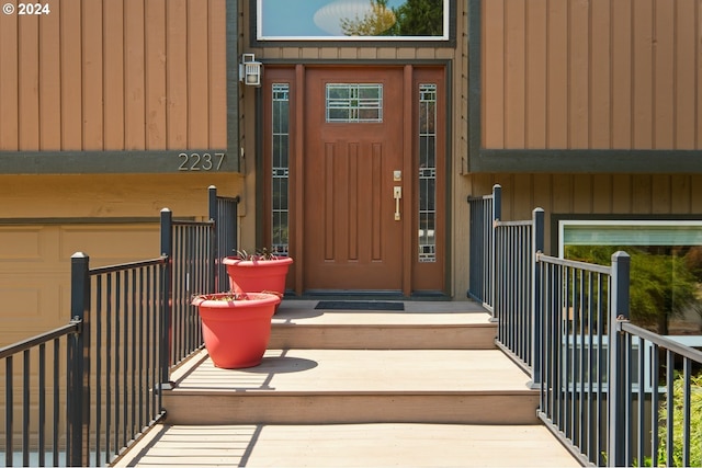 doorway to property with a garage