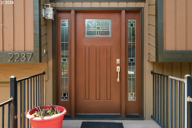 property entrance featuring board and batten siding