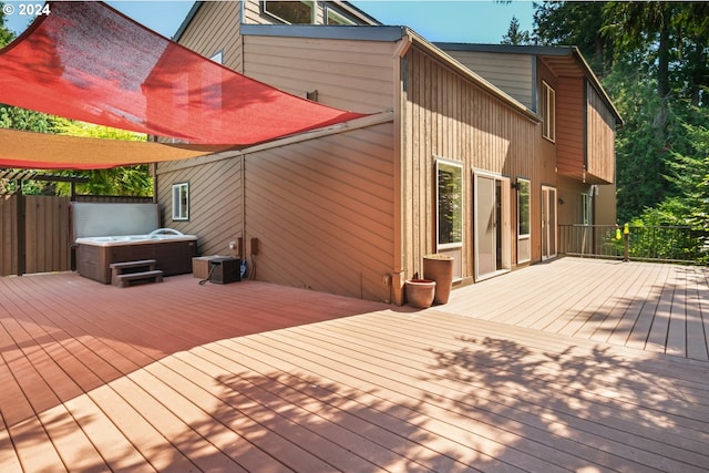 wooden terrace featuring a hot tub