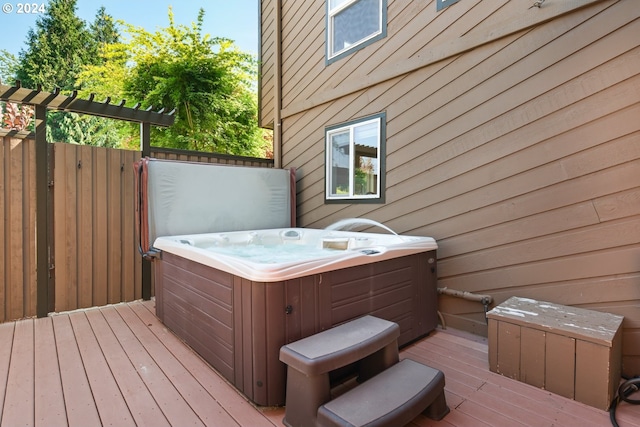 wooden deck with a hot tub