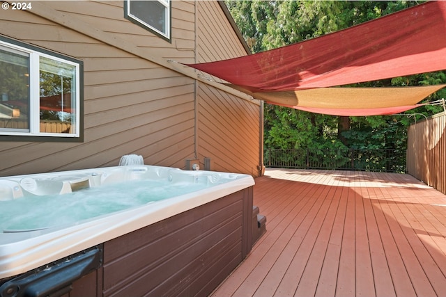 wooden terrace with an outdoor hot tub