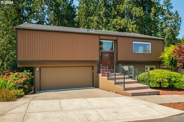 split foyer home featuring an attached garage and concrete driveway