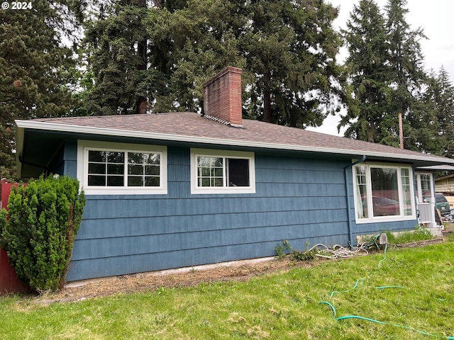 view of side of property featuring a yard