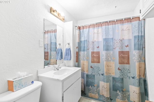 full bath with a shower with curtain, toilet, vanity, and a textured wall