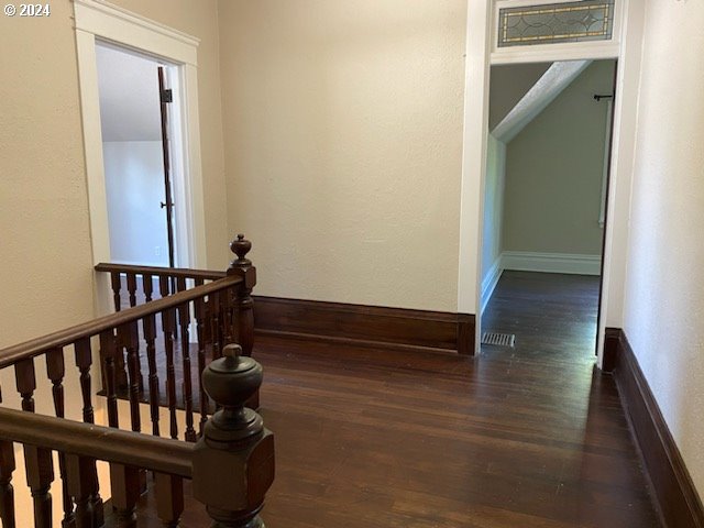 hallway with dark hardwood / wood-style floors