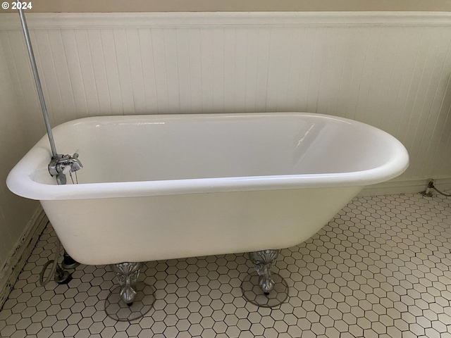 bathroom with tile patterned flooring and a bathtub