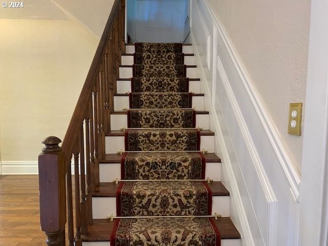 stairway featuring wood-type flooring