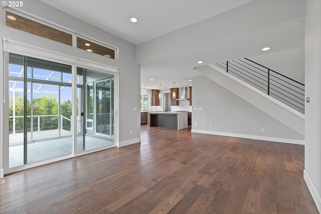 13560 SW Whitworth Ct, Beaverton, OR 97005 - unfurnished living room with dark wood-type flooring, recessed lighting, baseboards, and stairs