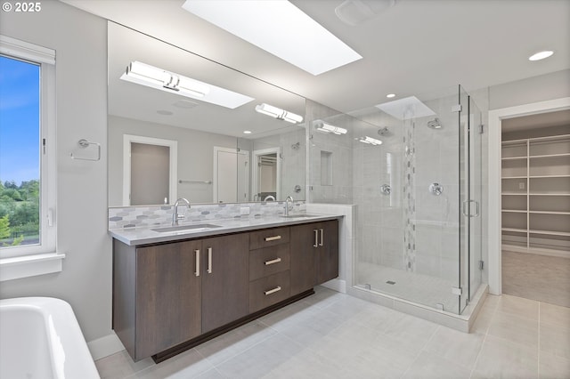 13560 SW Whitworth Ct, Beaverton, OR 97005 - bathroom with a stall shower, plenty of natural light, double vanity, and a skylight