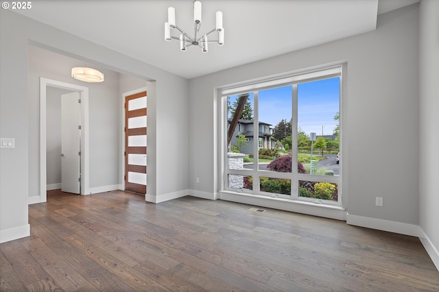 13560 SW Whitworth Ct, Beaverton, OR 97005 - spare room with a chandelier, wood finished floors, and baseboards