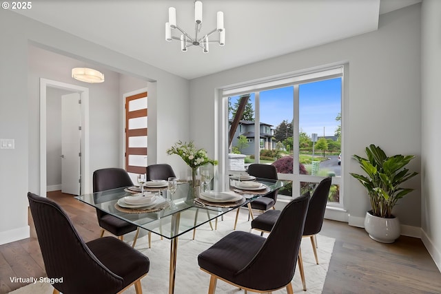 13560 SW Whitworth Ct, Beaverton, OR 97005 - dining space with a chandelier, wood finished floors, and baseboards