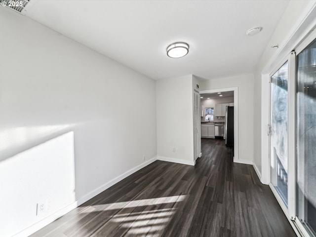 hall with dark wood-type flooring