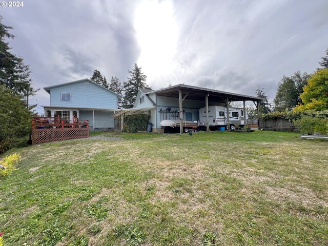 rear view of property featuring a yard