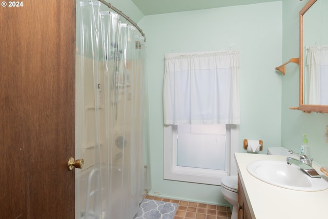 bathroom featuring tile patterned flooring, toilet, vanity, and a shower with shower curtain