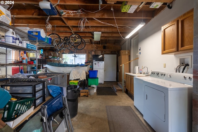 interior space with washing machine and clothes dryer and cabinets