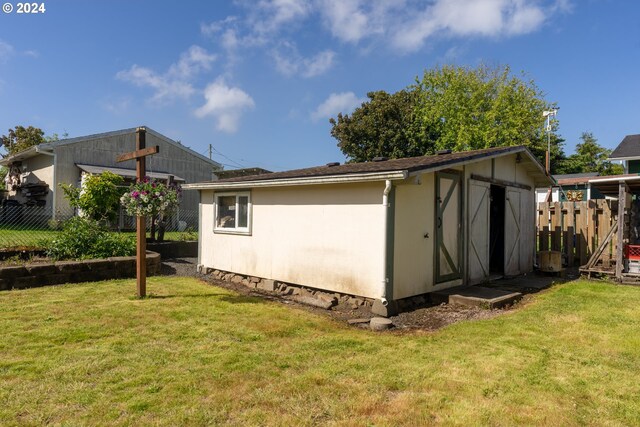 view of home's exterior featuring a yard and a storage unit