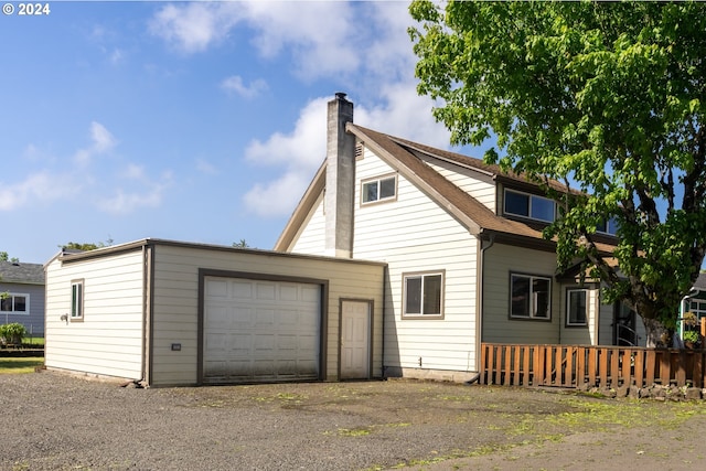 rear view of property with a garage