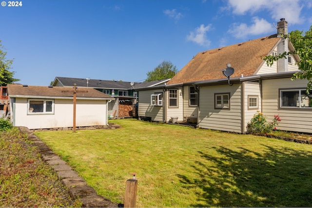 rear view of property featuring a lawn