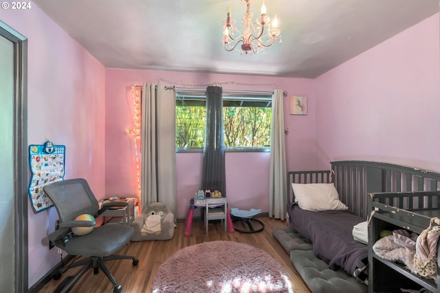 bedroom with wood-type flooring and a chandelier