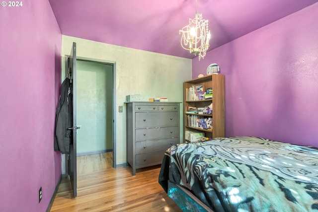 bedroom featuring a notable chandelier and light hardwood / wood-style flooring