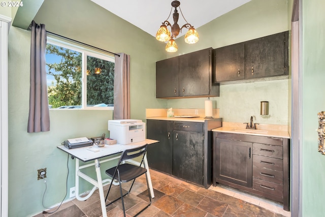 kitchen with dark brown cabinets, an inviting chandelier, hanging light fixtures, and sink