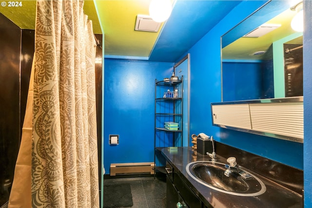 bathroom with vanity and a baseboard heating unit