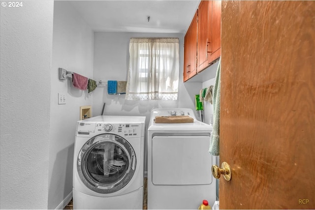 clothes washing area with cabinet space and separate washer and dryer