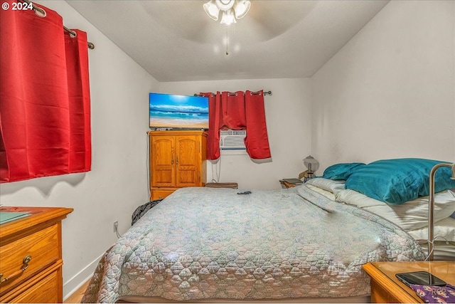 bedroom featuring cooling unit, ceiling fan, and baseboards