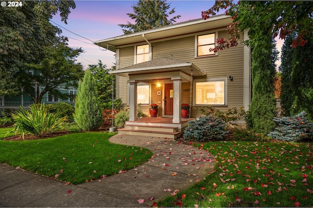 front facade featuring a lawn and a porch