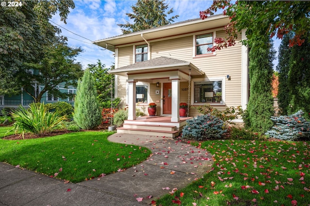 view of front facade with a front yard and a porch