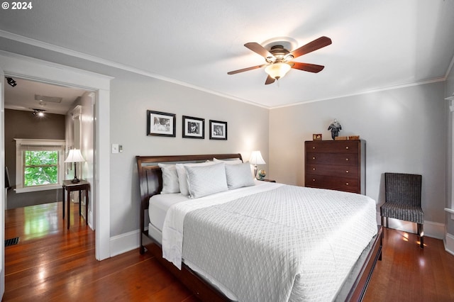 bedroom with dark wood-type flooring, crown molding, and ceiling fan