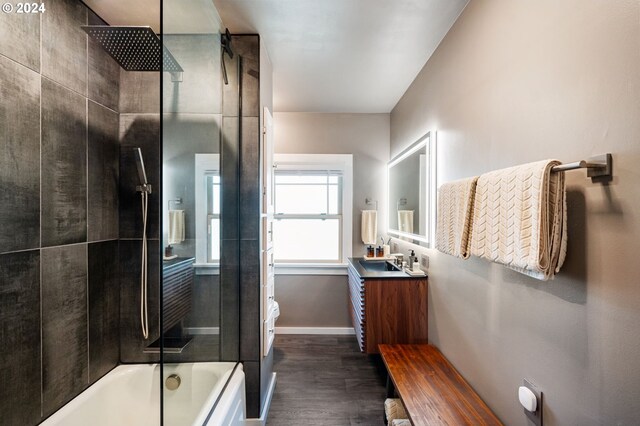 bathroom featuring vanity, hardwood / wood-style floors, and tiled shower / bath combo