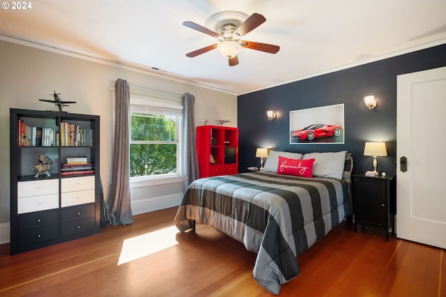 bedroom featuring ornamental molding, hardwood / wood-style flooring, and ceiling fan