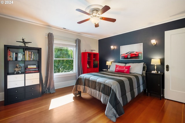 bedroom with visible vents, baseboards, ceiling fan, crown molding, and wood finished floors