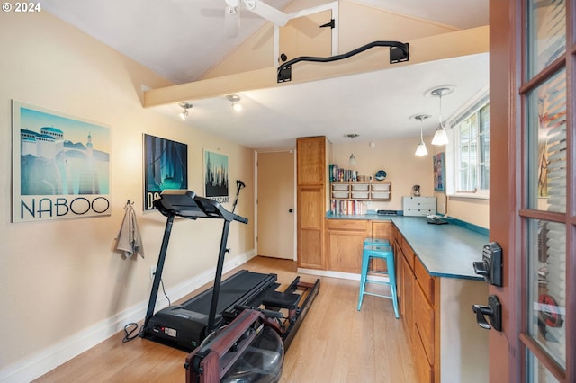 exercise area featuring ceiling fan, light wood finished floors, baseboards, and lofted ceiling