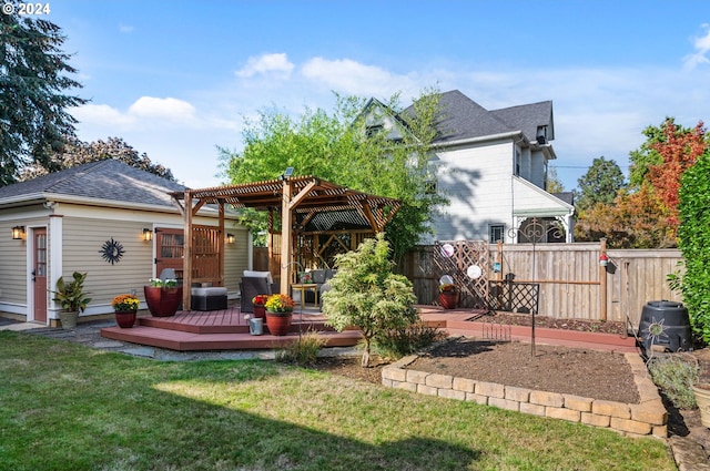 back of house featuring a pergola, a wooden deck, a yard, fence, and a shingled roof