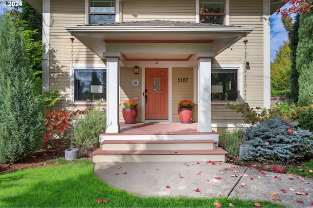 view of exterior entry with covered porch