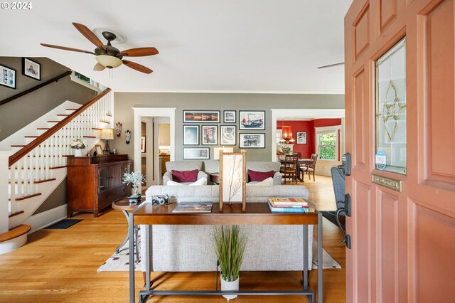 living room featuring light wood-type flooring and ceiling fan