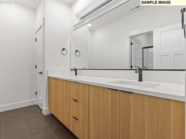 full bath featuring baseboards, visible vents, a sink, tile patterned flooring, and double vanity