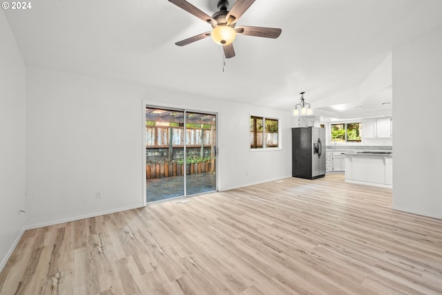 unfurnished living room with ceiling fan, light hardwood / wood-style flooring, and lofted ceiling