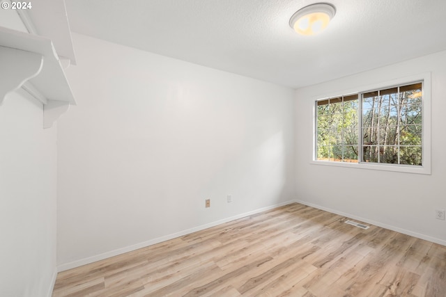 unfurnished room featuring light hardwood / wood-style floors